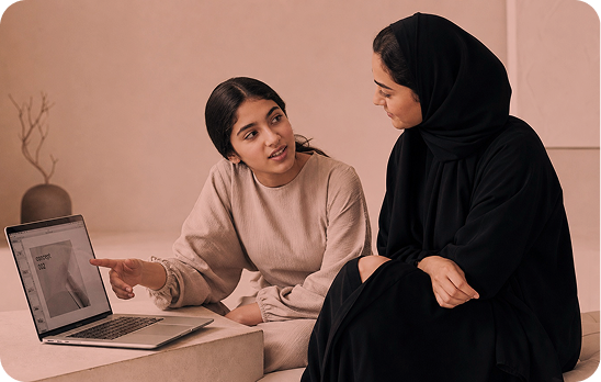 A parent and child talking together at a laptop
